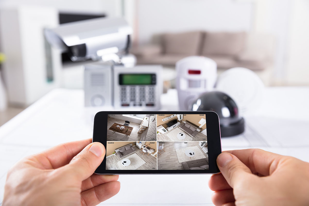Thief pressing the code for home alarm