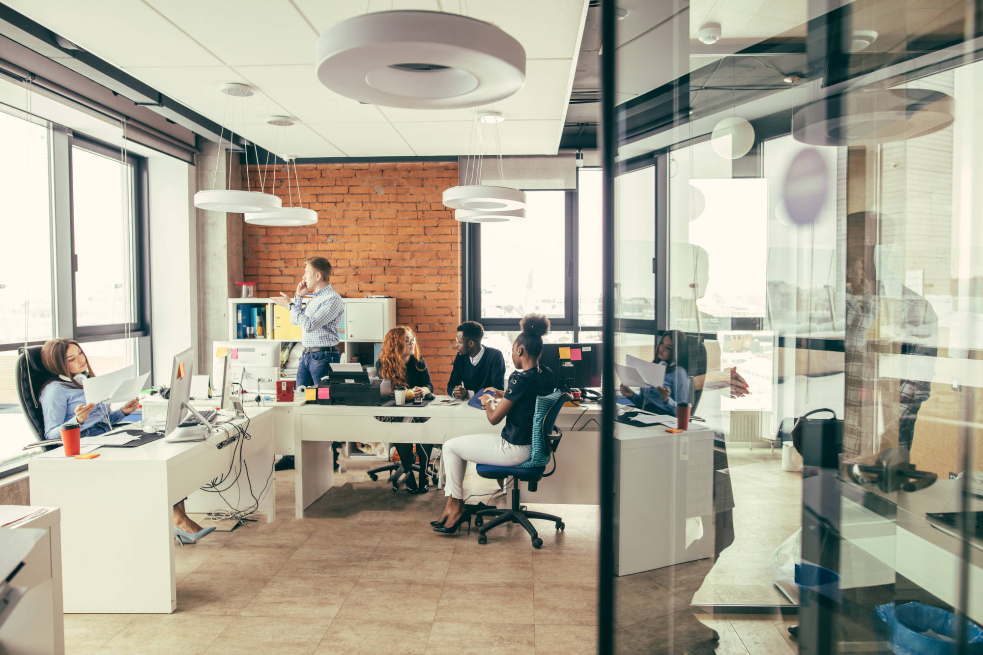 Interior office workspace computers and brick building